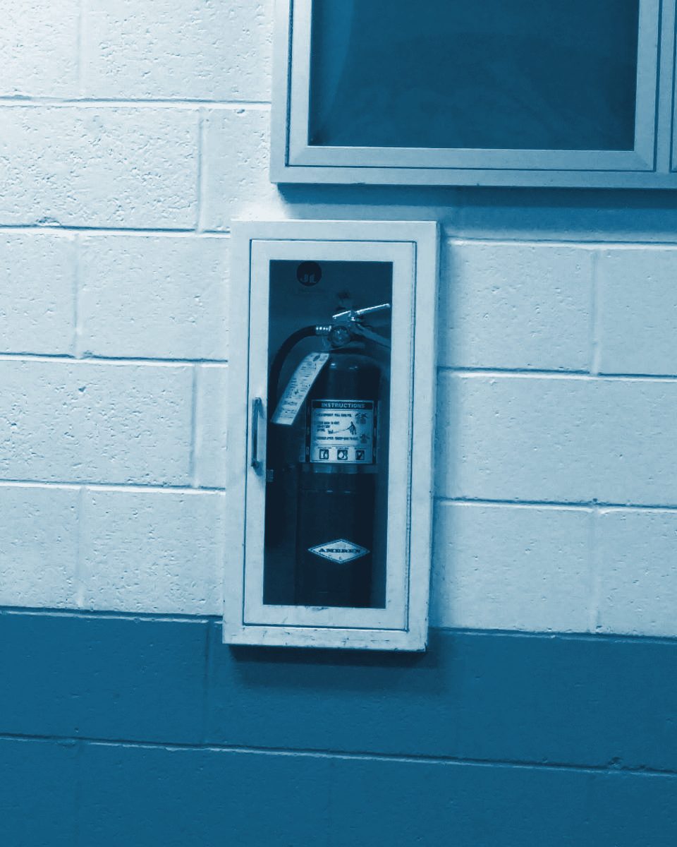 Fire extinguisher in a wall cabinet