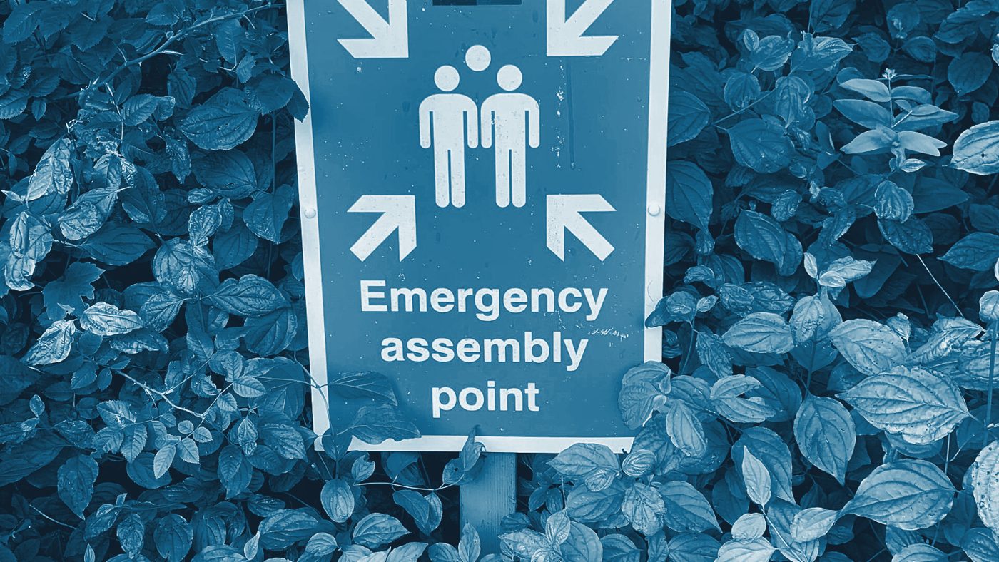 An emergency assembly point sign